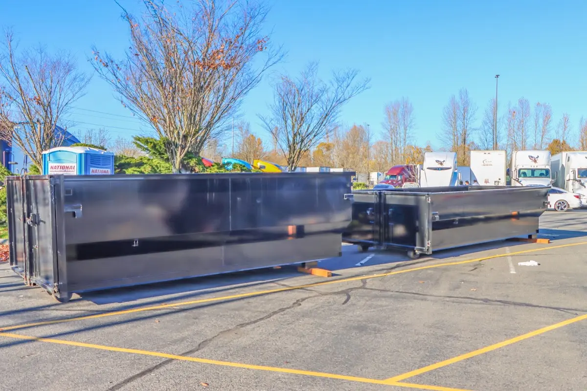 Professional dumpster rental service with roll-off container on residential driveway in Chantilly
